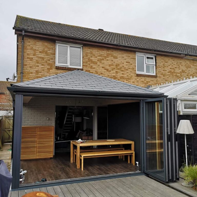 Insulated replacement roof with aluminium bi-fold doors